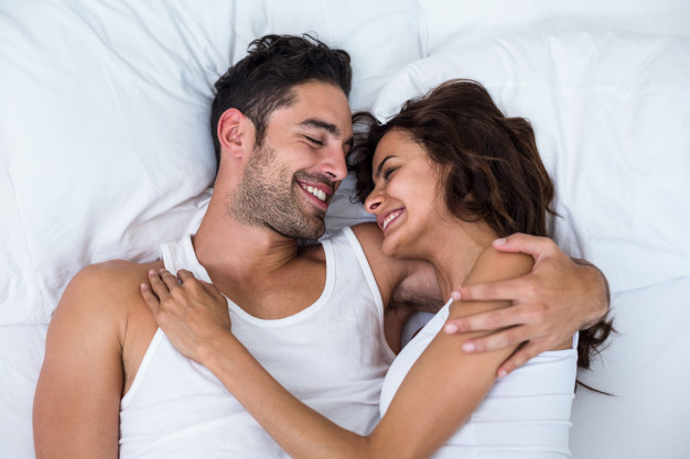 high-angle-view-happy-couple-relaxing-bed_107420-21457